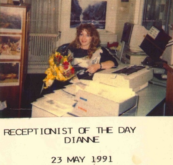 Di sitting behind her work desk