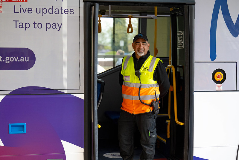bus drive standing in bus rear doorway