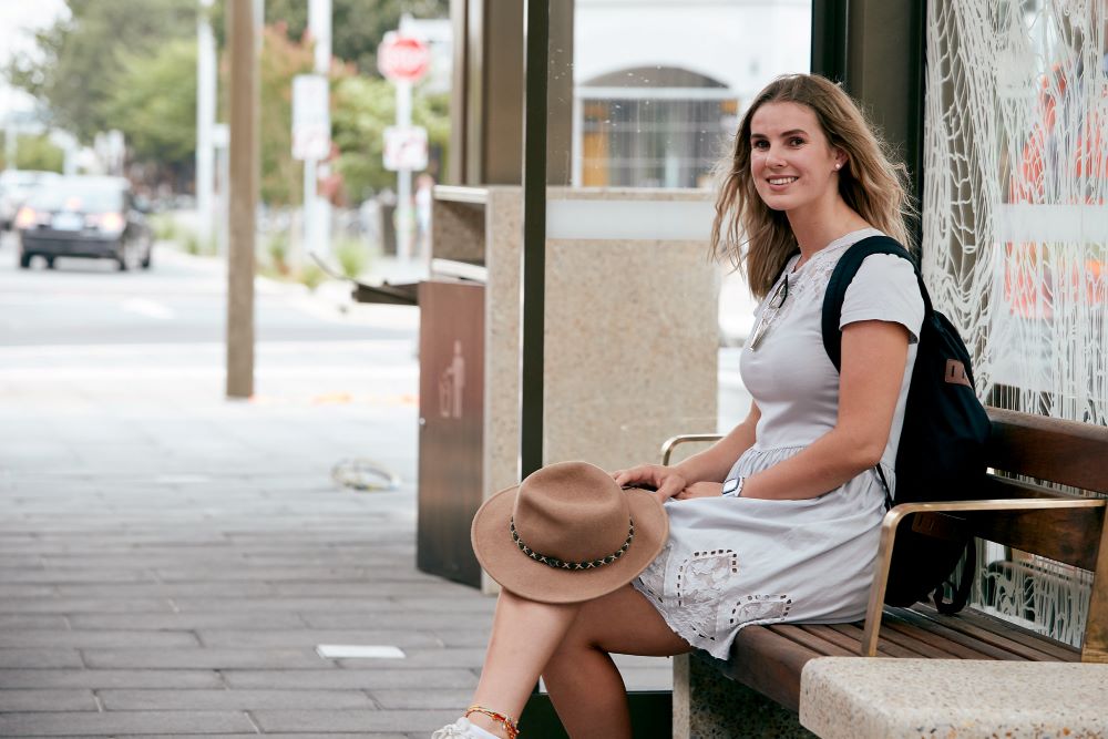 Person sitting at bus stop