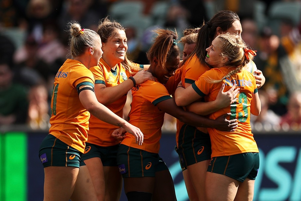 Australian Wallaroos rugby players on the field during a match.